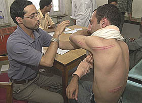 Photojournalist Rafiq Maqbool being examined at a hospital in Srinagar.
