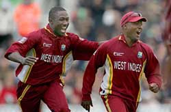 The West Indies Wavell Hinds (L) celebrates with captain Brian Lara following the dismissal of Englands Andrew Flintoff during their ICC Champions Trophy final at the Oval on Saturday. 