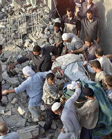 Iraqi men carry a body