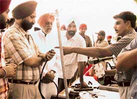 Punjab Parliamentary Secretary for Agriculture Sukhjinder Singh Randhawa being explained the working of sprinkler system after he inaugurated a seminar