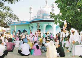 Devotees sit in front of Guga Marhi at the Chhapar Mela near Ludhiana which began on Sunday