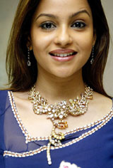 Television actress Gurpreet Kohli smiles as she displays a diamond necklace valued at $1 million at a show during the India launch of Orra