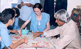 President A.P.J. Abdul Kalam joins a group of special children using water colours at Raphael Home in Dehra Dun on Monday.