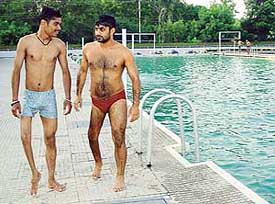 Ram Kiran  and Harmail Singh at the practice session of swimming in Panjab University on Tuesday. 