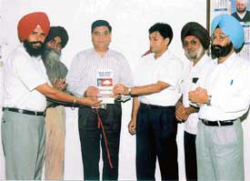 Mr Naresh Nagpal third from left, Additional Director, Technical Education and Industrial Training, releases a book, "Value-Based Education", authored by Dr Major Singh Randhawa 