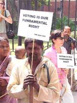Members of the Disabled Right Group hold a demonstration at the Election Commission Office demanding postponment of Assembly elections, in New Delhi