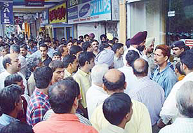 Traders protest against demolition in front of a showroom in Sector 17, Chandigarh, on Wednesday. 