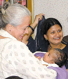 Socialite Nafisa Ali with an infant at a World Children's Day function in the Capital on Wednesday.