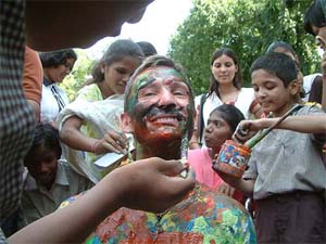 Special children apply paint on the face of Swedish artist Jonas Olsson during an international charity programme Humanity Art Project in Bhopal on Wednesday. 