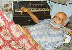 A bed-ridden Lachhman Dass Sandhu, 80-year-old special class artiste of AIR, tries his hand at the harmonium in Chandigarh on Thursday.