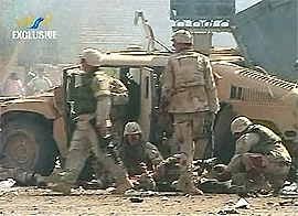 US soldiers tend to their injured colleagues after a bomb exploded in Baghdad on Thursday