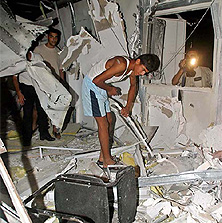 Palestinians inspect the rubble of an office belonging to Hamas after it was hit by Israeli helicopters in Gaza city on Thursday