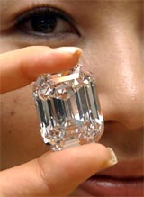 Model Tomoko Misawa shows off the reportedly worlds most valuable diamond in Tokyo on Friday. The diamond is certified as 100-carat, D-color and flawless and will be on a special display at a Tokyo department store with a price tug of 2.94 billion yen ($26.6 million) from October 9. 