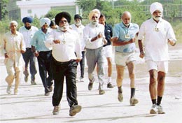 Senior citizens take part in 1,500 m fast walk at Phase VIII, Mohali, on Friday.