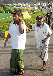 Senior citizens participating in a walk on the occasion of International Day of Older Persons at the India Gate in the Capital.