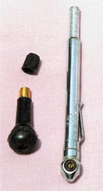 A valve stem assembly (left) and a tyre pressure gauge.