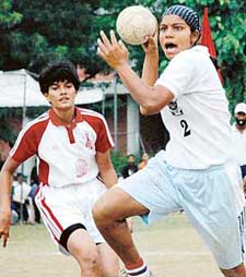 Harvinder Kaur of Panjab University attempts a shot against M.G. University, Kottayam, during the All-India Inter-University Handball Championship at Panjab University, Chandigarh