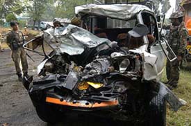 Army jawans look at the damaged Tata Sumo after an accident at Awantipora, outside a police station. 