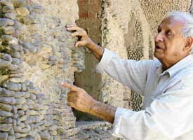 Rock Garden creator Nek Chand laments the desecration of one of his works by irresponsible visitors, who have been spoiling its beauty by pulling out stones engraved in walls