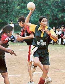 Anita Yadav of Pt. Ravishankar Shukla University, Raipur, attempts a shot against Nagpur University during All-India Inter University Handball Championship at Panjab University