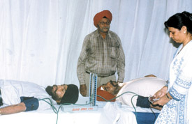 People donating blood at a camp, organised by Jangpura 
