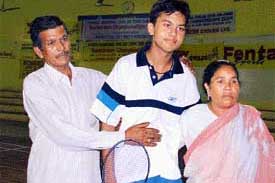 Promising shuttler Raj Kumar is congratulated by his parents after winning two titles in the Punjab State Sub-Junior Harish Chander Badminton