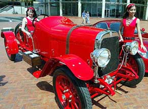 Models Melinda Smith, left, and Claudia Gutierrez show off the very first Alfa Romeo, the G1 in Sydney on Tuesday. 