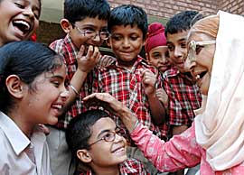 An inmate of Old Age Home, Sector 15, Chandigarh, shares a joke with the students of Shemrock School, Mohali, on Tuesday