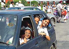 Parents ferry children to schools on Tuesday; and (right) buses impounded at traffic police lines, Sector 29, Chandigarh.