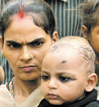 Nine-month-old Shani with his mother in the Capital on Tuesday.