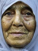 An elderly Palestinian woman prays at the funeral of Wafi Asaluah, who Palestinian medics said was killed by Israeli troops