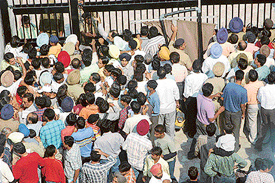 Hundreds of hockey fans mill around outside a gate of the stadium in Sector 42, Chandigarh, on Wednesday.