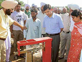 Mr Anurag Verma, Deputy Commissioner, Ludhiana, checks the weight of a purchased paddy bag at a mandi in Ludhiana district on Wednesday.