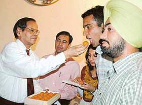 Prof K.N. Pathak, VC, Panjab University, offers sweets to office-bearers of the students council after the swearing-in ceremony