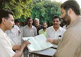 Chairman of the Sanitation Committee Chander Mukhi Sharma inspects the duty register of safai karamcharis in Sector 17 Chandigarh