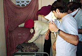 The Senior Superintendent of Police, Mr G.P.S. Bhullar, along with other senior officials of police, examines the site of the murder in Jalandhar on Thursday.