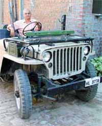 Honey William in his vintage Ford jeep