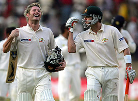 Australias Michael Clarke and team-mate Damien Martyn walk back to the pavillion at the close of the third days play of the first Test between India and Australia