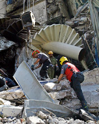 Israeli rescue workers search through the rubble for survivors of a bomb blast at Hilton Hotel in the Egyptian Red Sea resort of Taba