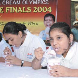 Schoolchildren at an ice cream-eating competition to celebrate ICE Cream Olympics 2004 at Nirulas at Vasant Vihar in the Capital