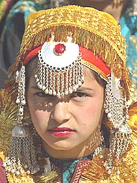 A Kashmiri Muslim girl, dressed in the traditional attire, waits for her turn to perform at a cultural show during her schools annual day function in Srinagar on Thursday.