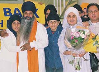 Mr Balbir Singh Bains with his family at the Heathrow Airport, London.
