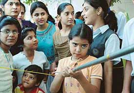 A student tries her luck at a fete held at Bhavan Vidyalya, Sector 27