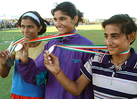 Komal  of Sonipat, who won the 400 meter race, flanked by Sunita from Hisar  and Manju from Sonipat  in Haryana State Games held at Tau Devi Lal Sports Complex