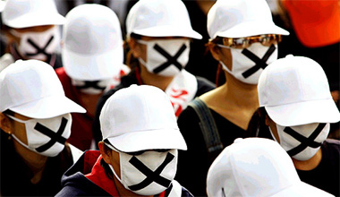 Wearing masks, South Korean sex workers take part in a rally demanding state recognition of their occupation in Pyongtaek on Monday. About 500 women protested against the governments enforced new anti-prostitution laws against traffickers, pimps and clients.