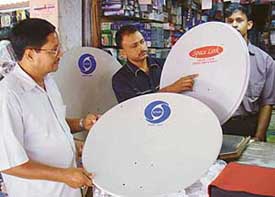A dealer in Chandigarh displays satellite dishes for DTH broadcasting