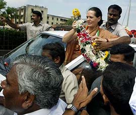 Ms Sonia Gandhi receives garlands from her supporters during a road-show on the last day of election campaigning in Mumbai on Monday. 