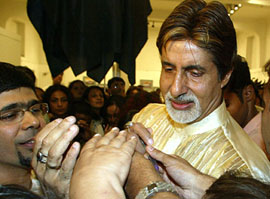 Bollywood icon Amitabh Bachchan signs an autograph on his 62nd birthday in Mumbai on Monday.