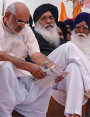 Former Chief Minister of Delhi Sahib Singh Verma reads The Tribune at the election rally organised by the Shiromani Akali Dal (Badal) in Kapurthala on Monday. Mr Parkash Singh Badal is also seen in the picture.