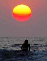  Balinese surfer heads toward sunset to mark the second anniversary of the Bali bomb blasts
